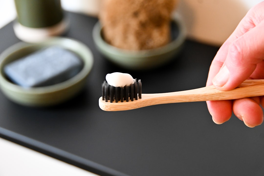 Bamboo toothbrush on a calm minimal surface